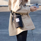 Arenzza outdoor multifunctional bag with multiple compartments, black fabric, and adjustable straps, designed for versatile outdoor use.