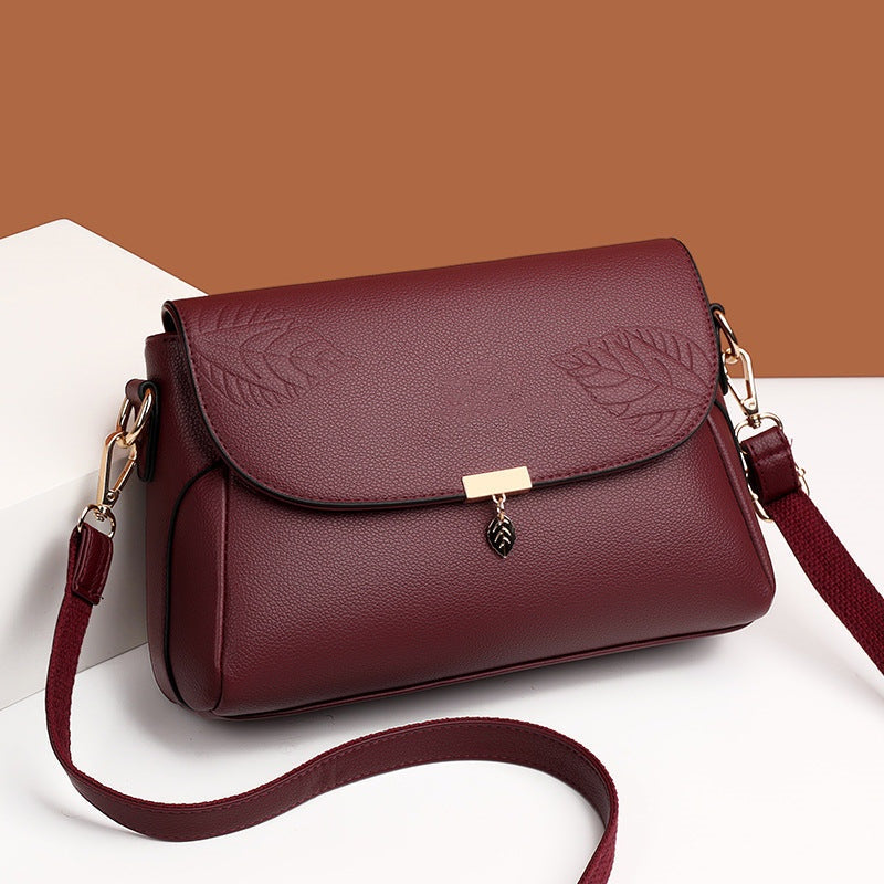 Multi-layer women's leather bag by Arenzza featuring a stylish, multi-compartment design with elegant leather straps.