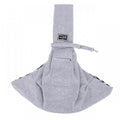 Arenzza dog sling carrier bag holding a small dog, with adjustable straps and soft fabric for comfortable pet transport.