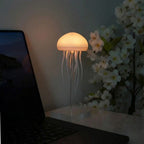 Aarenzza JellyFlow™ Rechargeable Floating Jellyfish Lamp with realistic jellyfish design floating in water, illuminated with soft LED light.