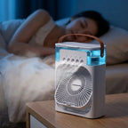 A person using the AquaBreeze™ Compact Desk Air Cooler by Arenzza on a workspace, showing the portable cooling device on a desk.