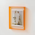 Clear acrylic picture frame by Arenzza, minimalist wall-mounted frame showcasing a photo with sleek, transparent design.