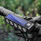 Arenzza solar and USB rechargeable bicycle light mounted on a bike, showing bright LED beam and sleek compact design.