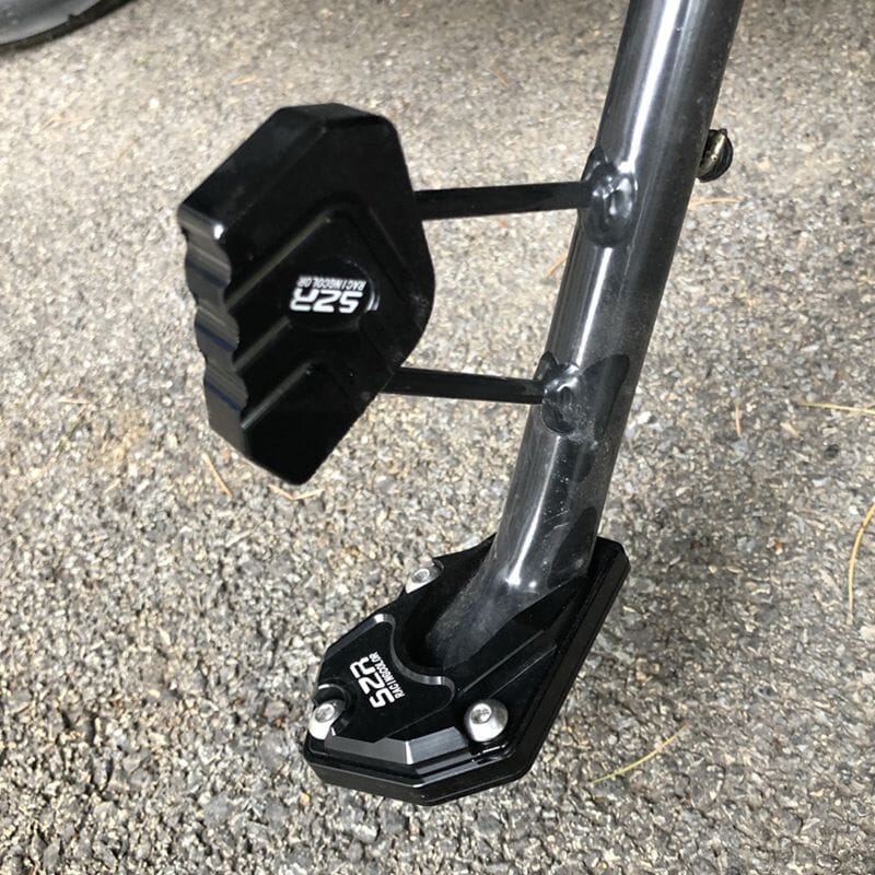 Arenzza motorcycle kickstand foot extension for side stand, showing the metal extension piece on a motorcycle side stand.