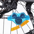 Arenzza bike chain scrubber for bike maintenance, shown cleaning a bicycle chain with durable plastic bristles.