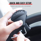 Arenzza steering wheel booster knob attached to car steering wheel for easier driving, displayed in a close-up view.