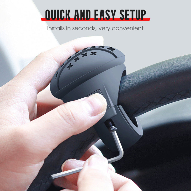 Arenzza steering wheel booster knob attached to car steering wheel for easier driving, displayed in a close-up view.