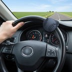 Arenzza car steering wheel booster knob attached to a steering wheel for easier driving, shown in a close-up view.