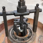 Arenzza multi-function 3-jaw bore puller tool for cars, showing its adjustable jaws for removing tightly fitted components.