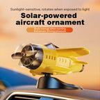 Arenzza solar-powered airplane-shaped car ornament attached to a vehicle's dashboard or rearview mirror.