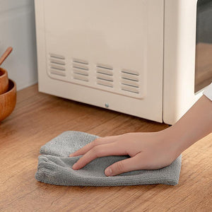 Arenzza multifunction retractable microfiber dust brush gap mop for cleaning tight spaces and surfaces, shown in use.