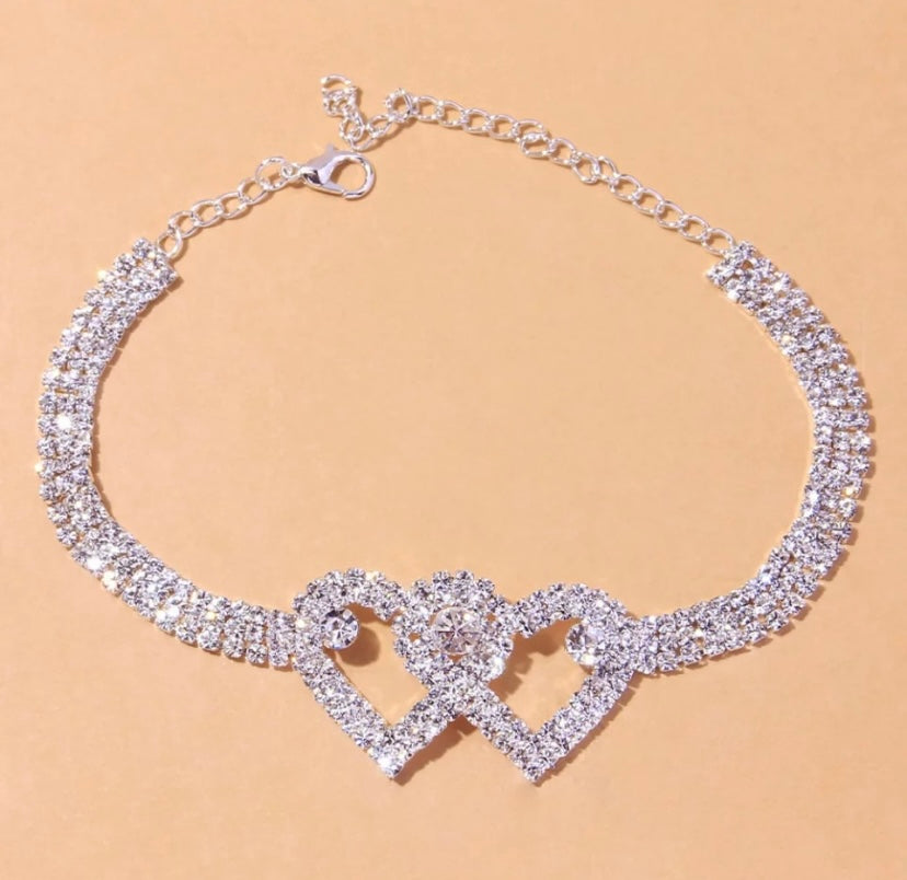 Arenzza Heart X Heart ankle bracelet with delicate chain and heart charms, displayed on a neutral background.