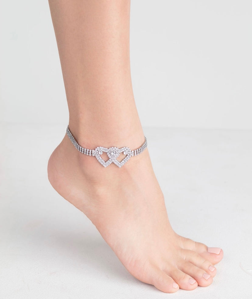 Arenzza heart X heart ankle bracelet with delicate chain and charm, shown on a model's ankle for clearance sale.