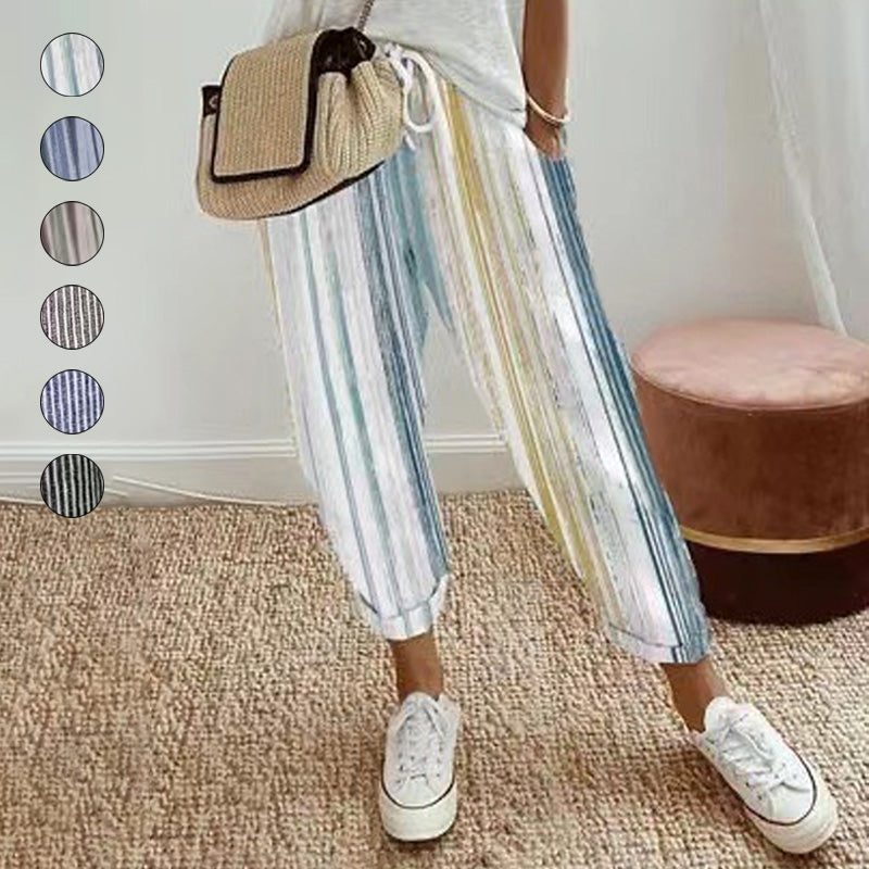 A woman wearing striped linen cotton trousers by Arenzza, showcasing effortless style and comfort in a casual outdoor setting.