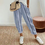 A woman wearing Arenzza striped linen cotton trousers, showcasing effortless style and comfort in a casual clothing setting.