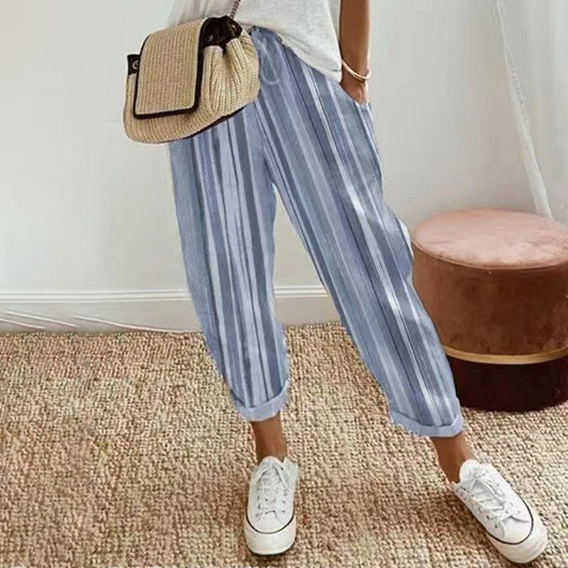 A woman wearing Arenzza striped linen cotton trousers, showcasing effortless style and comfort in a casual clothing setting.