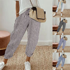 A woman wearing striped linen cotton trousers for women, showcasing effortless style and comfort from Arenzza.