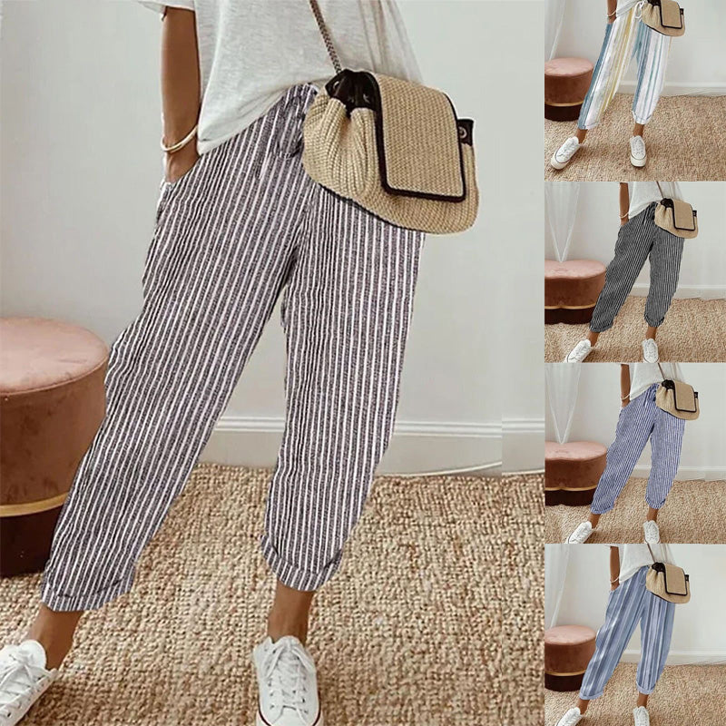 A woman wearing striped linen cotton trousers for women, showcasing effortless style and comfort from Arenzza.