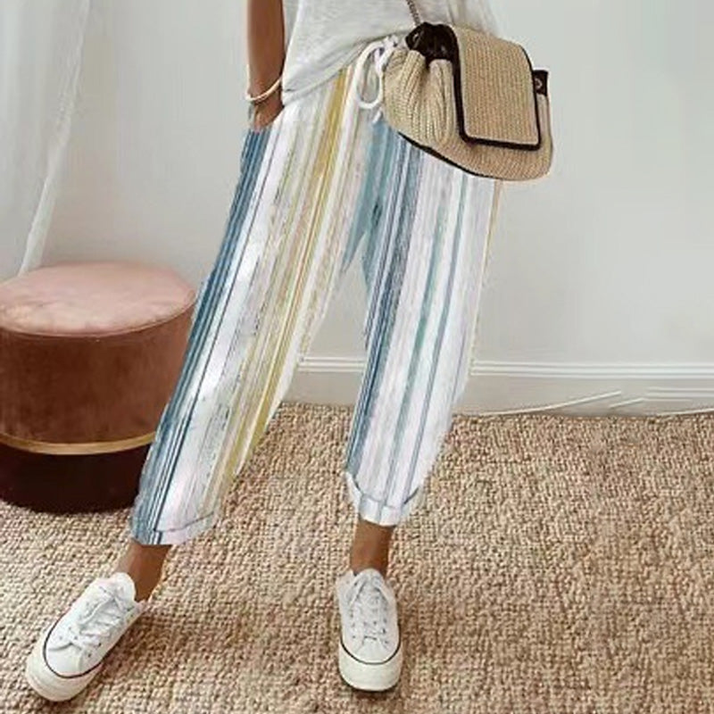A woman wearing striped linen cotton trousers from Arenzza, showcasing effortless style and comfort in a casual outfit.