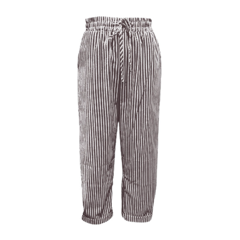 A woman wearing striped linen and cotton trousers from Arenzza, showcasing effortless style and comfortable fit.