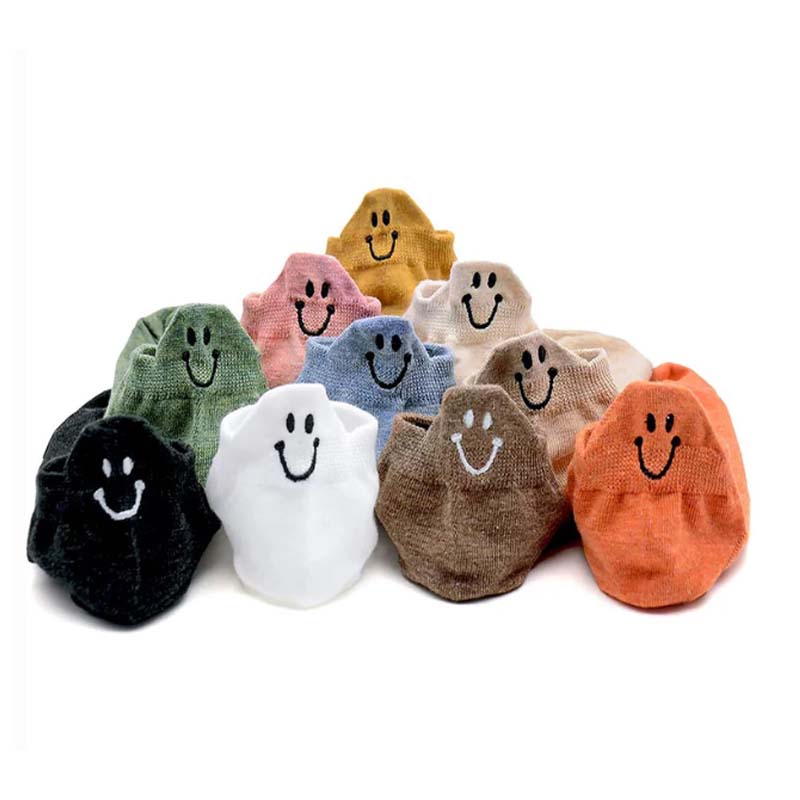 A pair of Arenzza 4 Seasons Cartoon Smiling Face Socks with colorful embroidered designs on soft fabric.