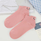 A pair of Arenzza 4 Seasons Cartoon Smiling Face Socks with colorful embroidered smiling faces on soft fabric.