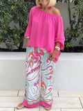 A woman wearing Arenzza women's two-piece outfit with stylish trousers and off-shoulder top, showcasing a casual and chic look.