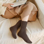 Five pairs of Arenzza women's solid mid-calf socks in various colors, displayed neatly in a row on a flat surface.