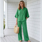 Arenzza women's stand-up collar top and wide-leg pants set, stylish clothing with a modern fit, shown in a flat lay style.