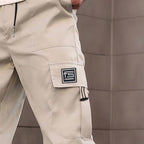 Men's Arenzza cargo pants with multiple pockets, straight-leg fit, durable fabric, in a neutral color, suitable for casual wear.