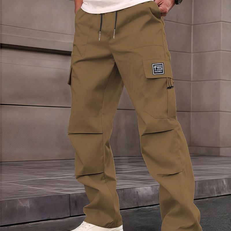 A pair of Arenzza men's multi-pocket straight-leg cargo pants with multiple functional pockets on beige fabric.
