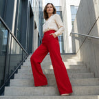 A woman wears high-waist wide-leg solid color trousers by Arenzza, showcasing the relaxed fit and sleek style.