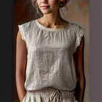A white sleeveless blouse with lace trim from Arenzza, featuring a relaxed fit and summer-ready style, displayed on a hanger.