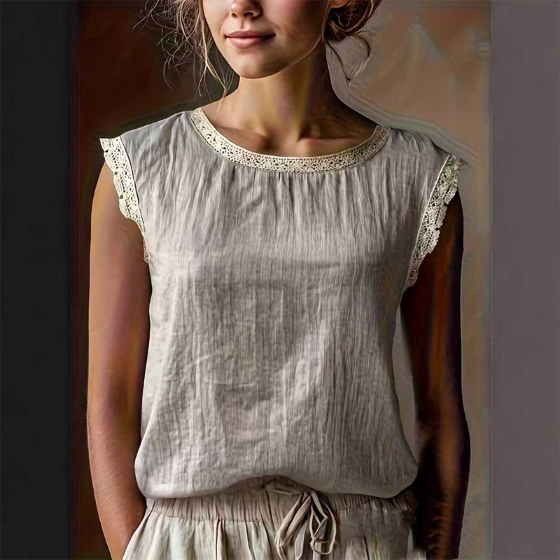 A white sleeveless blouse with lace trim from Arenzza, featuring a relaxed fit and summer-ready style, displayed on a hanger.