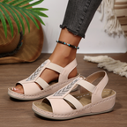 A pair of Arenzza women's summer rhinestone wedge sandals with open toes and ankle straps, featuring sparkling rhinestone embellishments.