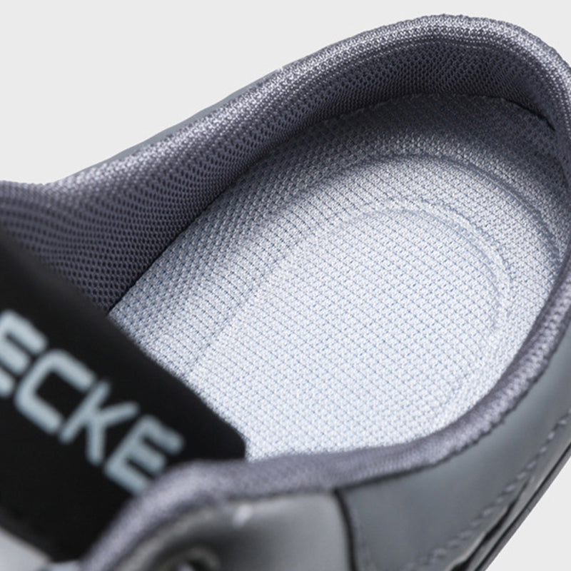 A pair of Arenzza men's breathable mesh slip-on half slippers with open toes and soft fabric, suitable for indoor comfortable wear.