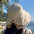 Arenzza women's wide brim sun hat with bowknot detail, foldable design, offering 360° sun protection in a stylish clothing accessory.