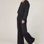 A woman wearing Arenzza women's 2-piece casual sweatsuit set, comfortable clothing for leisure and everyday wear.