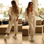 A woman wearing a casual hooded jumpsuit from Arenzza, showcasing its relaxed fit and comfortable hooded design.