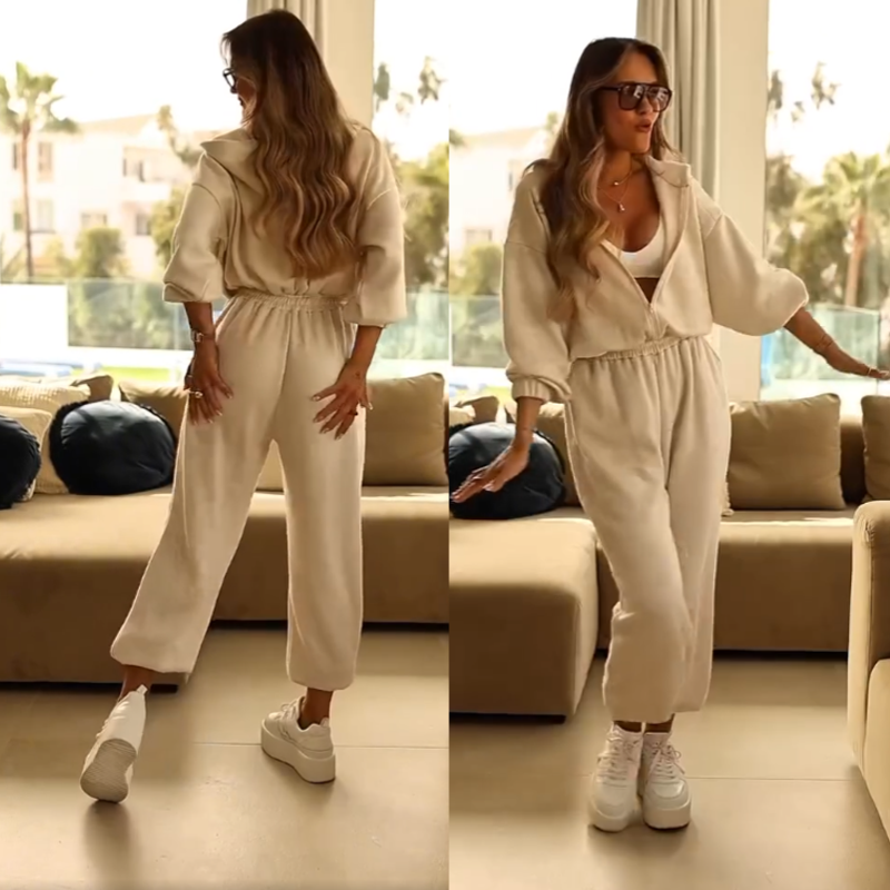 A woman wearing a casual hooded jumpsuit from Arenzza, showcasing its relaxed fit and comfortable hooded design.