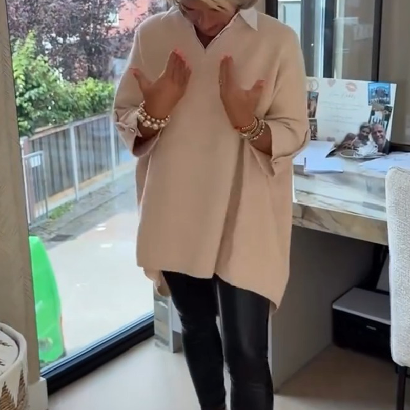 A women's long-sleeve top with shirt collar from Arenzza, shown in a neutral color with a fitted design and button detail.