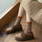 A pair of retro ethnic style socks from Arenzza featuring colorful traditional patterns, displayed flat on a white background.