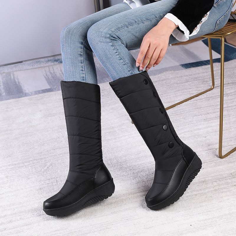A pair of Arenzza women's waterproof knee-high snow boots with warm lining, suitable for winter weather and snowy conditions.