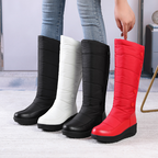 A pair of women's warm lined waterproof knee-high snow boots by Arenzza with thick rubber soles and cozy interior for winter wear.