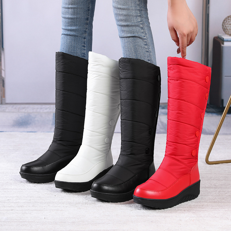 A pair of women's warm lined waterproof knee-high snow boots by Arenzza with thick rubber soles and cozy interior for winter wear.