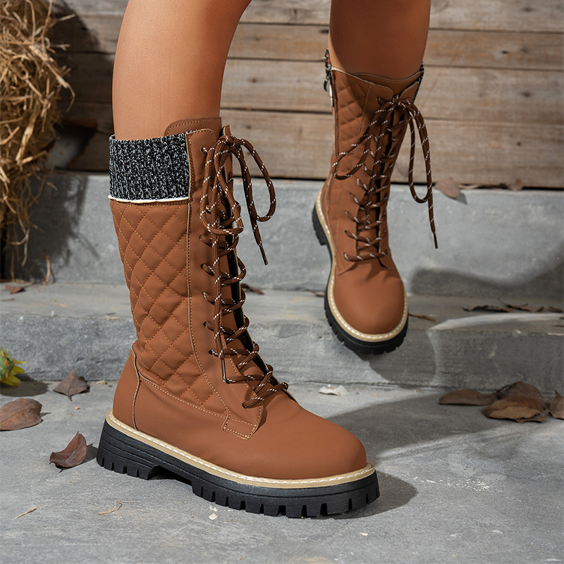 A pair of Arenzza women's quilted mid-calf winter boots with side zippers, featuring a warm, padded design for cold weather.