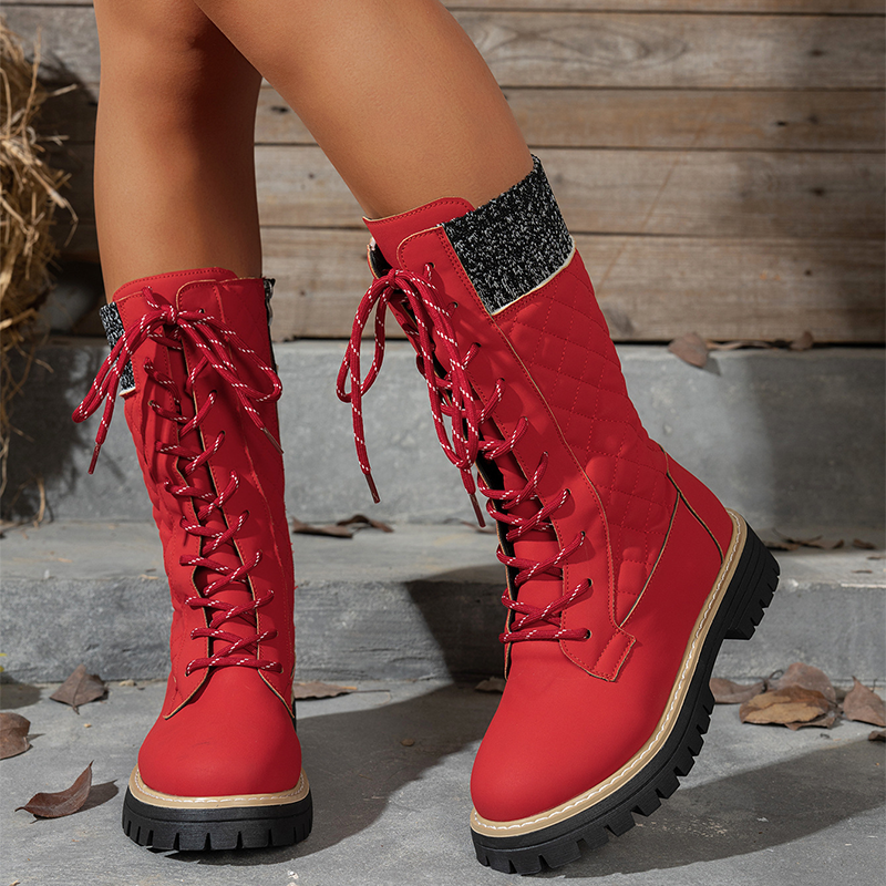 A pair of women's Arenzza quilted mid-calf winter boots with side zippers, featuring a padded design and winter-ready style.