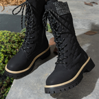 A pair of women's quilted mid-calf winter boots with side zippers by Arenzza, featuring a warm, insulated design for cold weather.