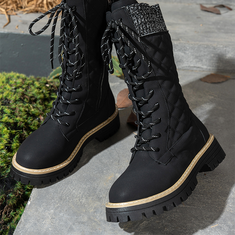 A pair of women's quilted mid-calf winter boots with side zippers by Arenzza, featuring a warm, insulated design for cold weather.