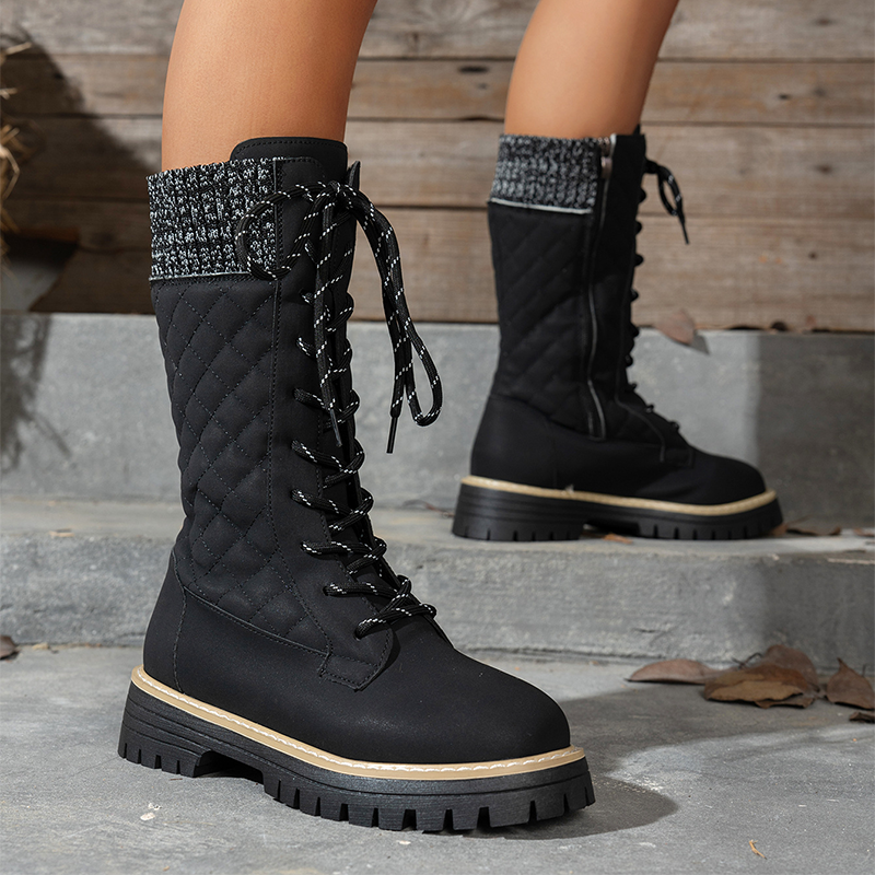 A pair of women's Arenzza quilted mid-calf winter boots with side zippers, featuring a warm, padded design for cold weather.
